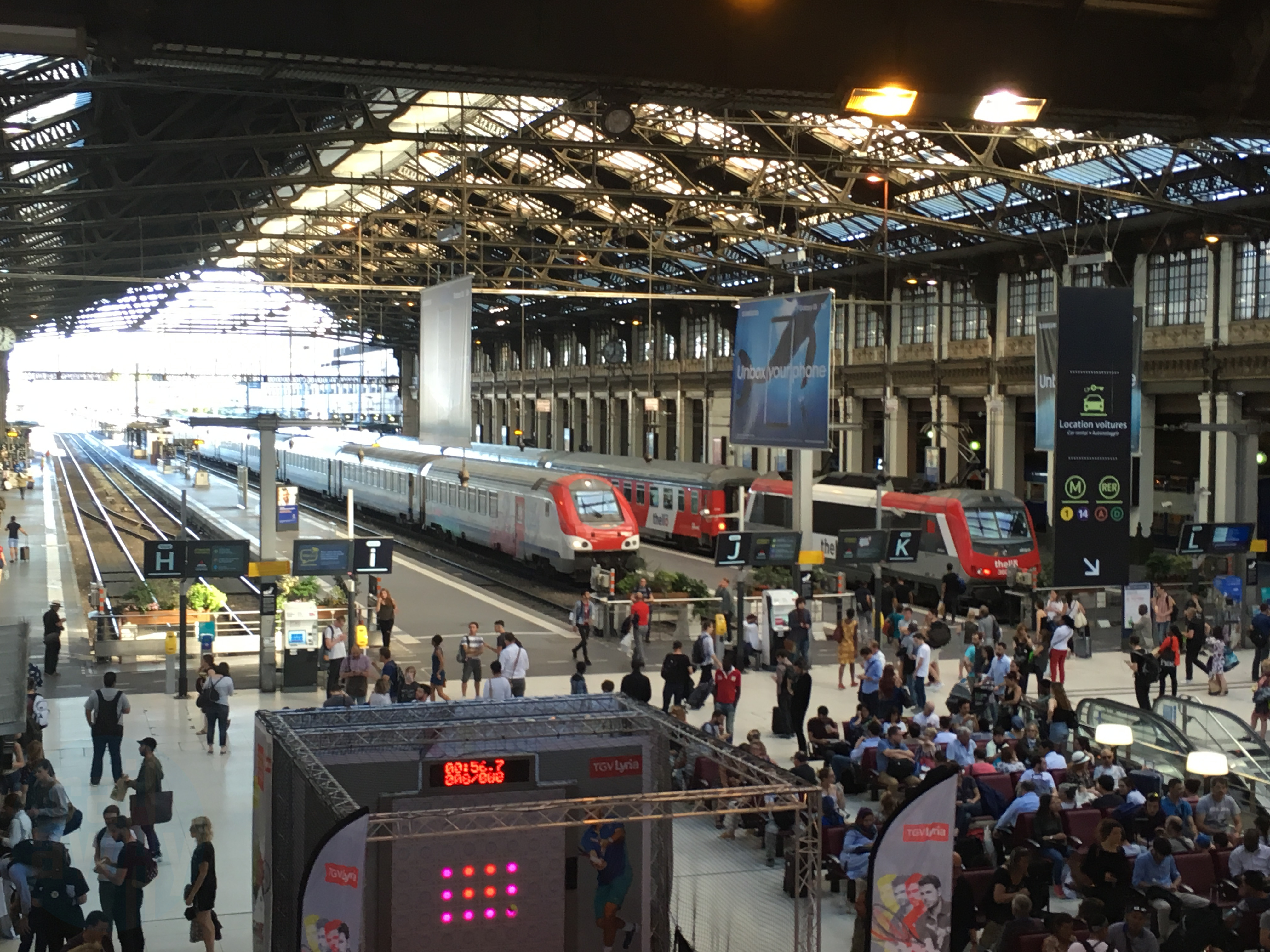 View of platforms at Paris Gare de Lyon with two trains in the background, one is the Thello train.