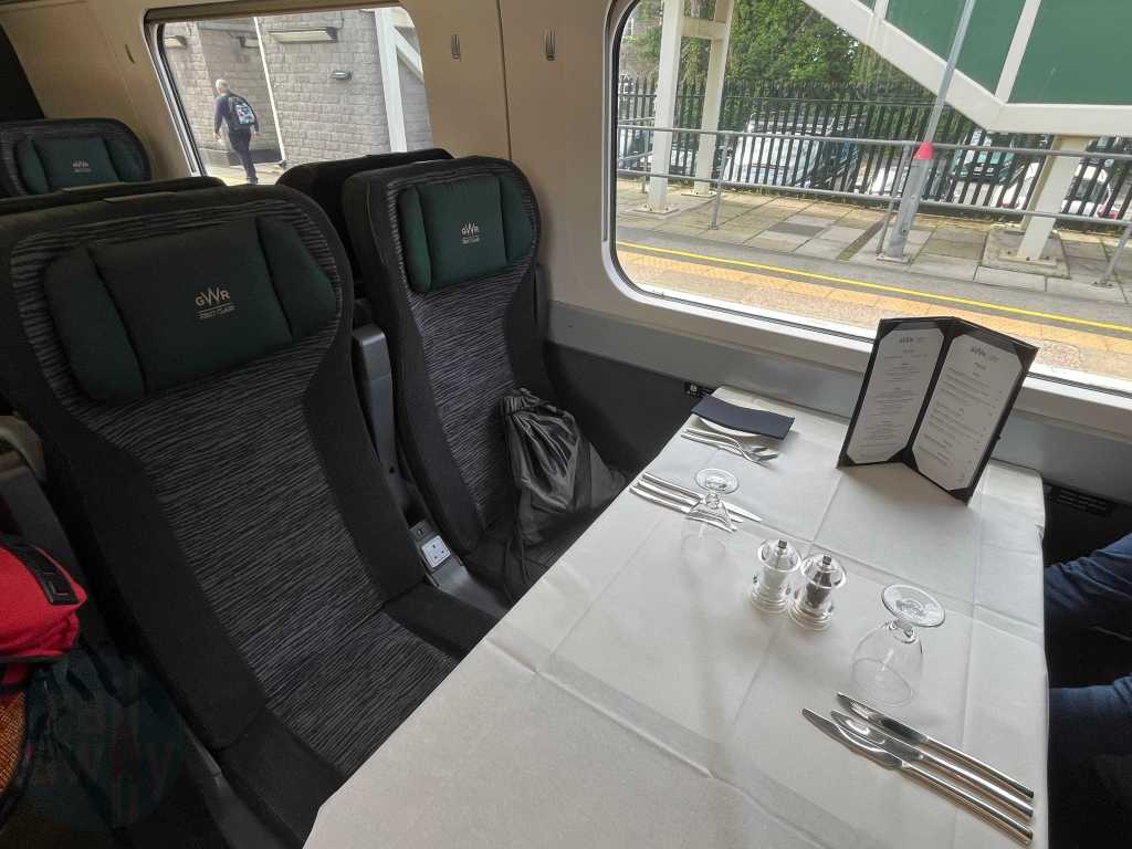 A table of four onboard the GWR Pullman Dining carriage with tables ready for service with tablecloths, menus and cutlery