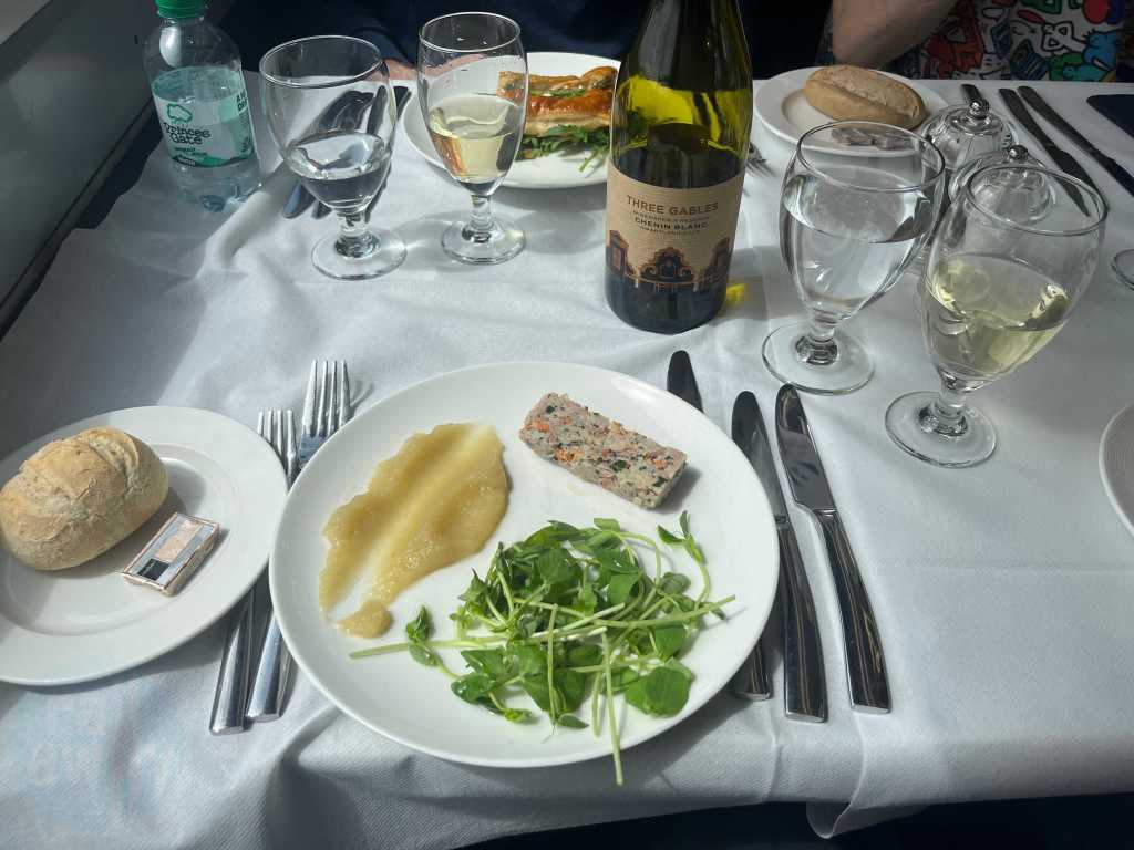 The ham hock starter on the GWR Pullman Dining train with a bottle of Chenin Blanc wine
