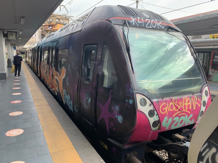 The purple ETR221 train exterior at Napoli Porta Nolana station