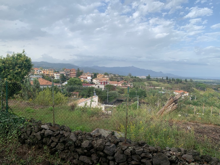Green fields and terracotta houses as can be seen from the train A small farm building surrounded by fields as can be seen from the train from Randazzo to Riposto