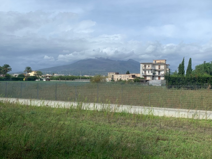 A view out of the window of the train of the volcano