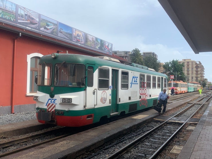 The one carriage train at Catania Borgo station heading to Randazzo. It is green and white with the letters FCE on the side and front.