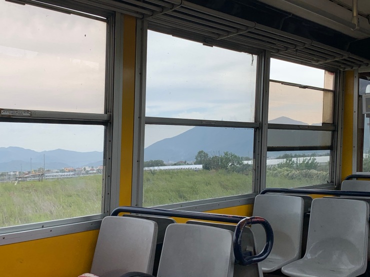 A view of the window with a volcano as a backdrop